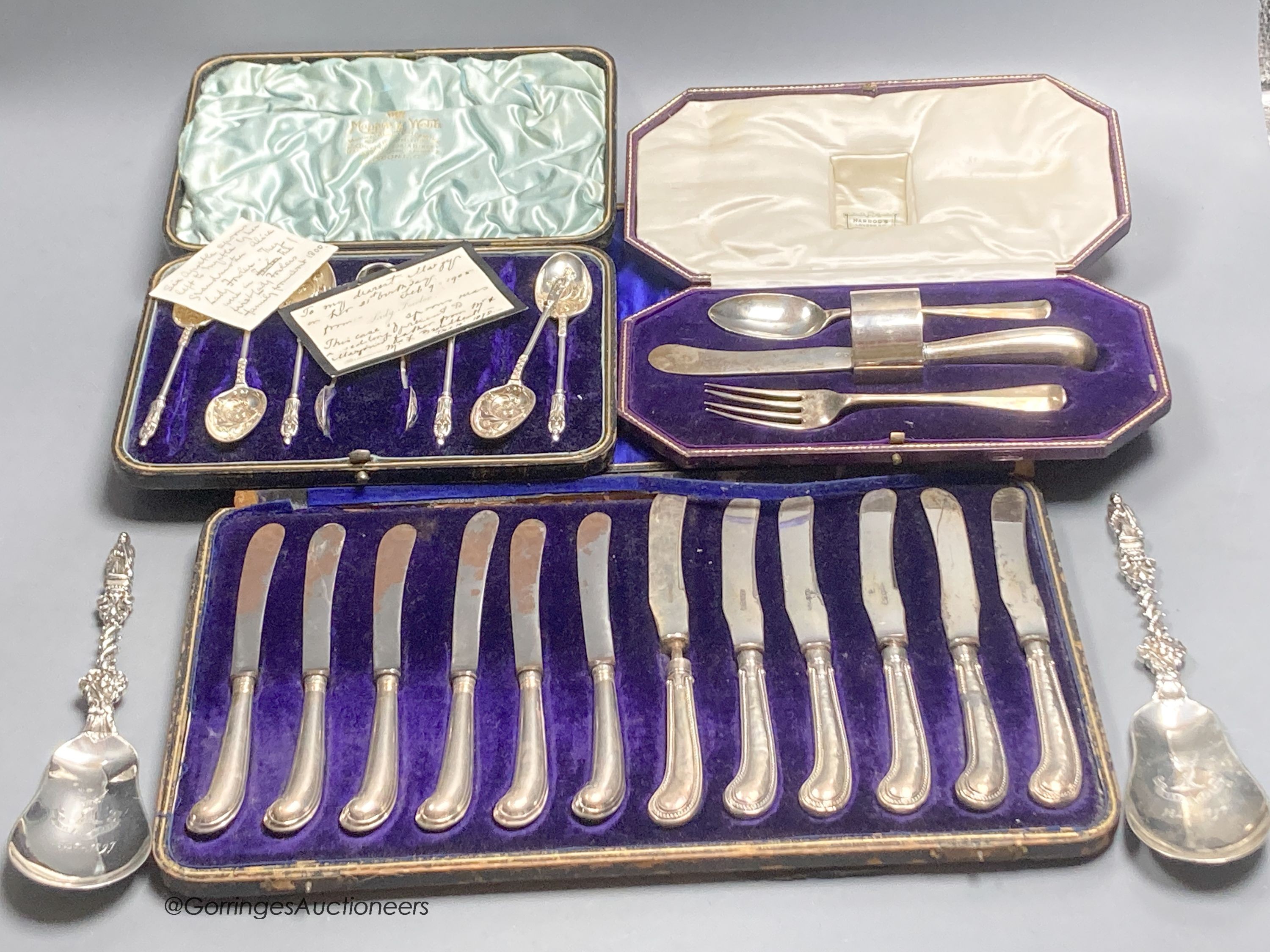A pair of late Victorian silver apostle serving spoons, William Hutton & Sons Ltd, London, 1895, 20.4cm and three cased sets, including christening set, cake knives and plated apostle spoons